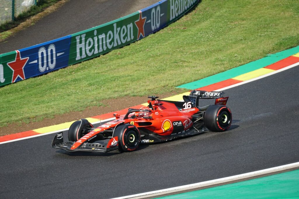 Will you be attending the next F1 race in England? An F1 car is parked on the raceway in the rain.