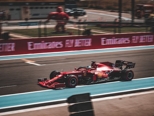 Will you be at the next F1 race in Hungary? A blurry F1 car is pictured sitting on the race track. 